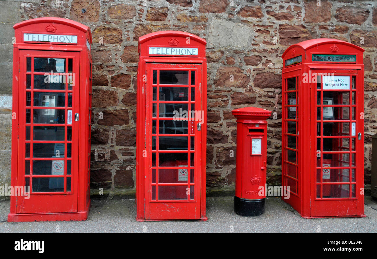 Three old red telephone boxes and a red letter box. Stock Photo