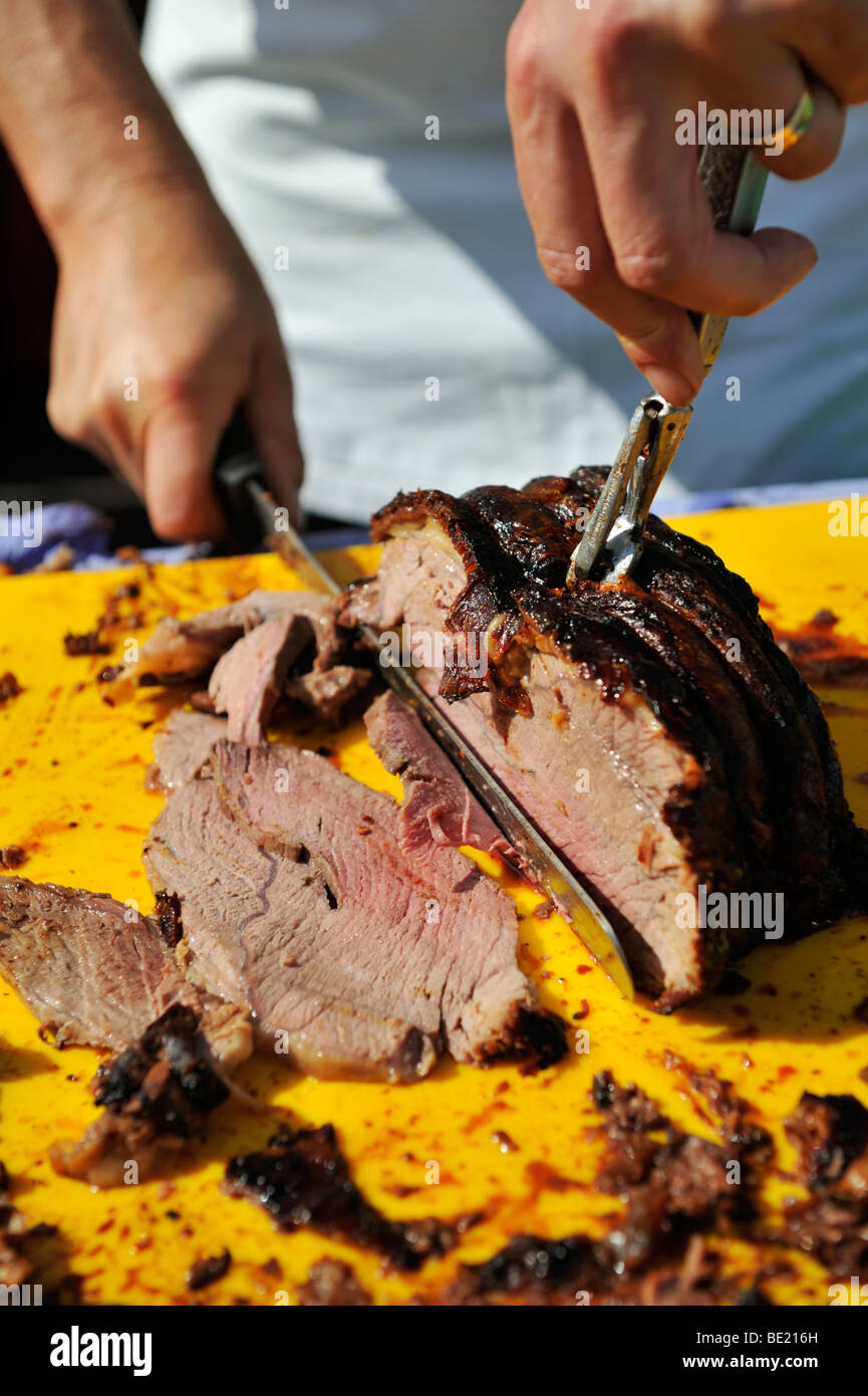 Chef carving slices of organic roast beef Stock Photo