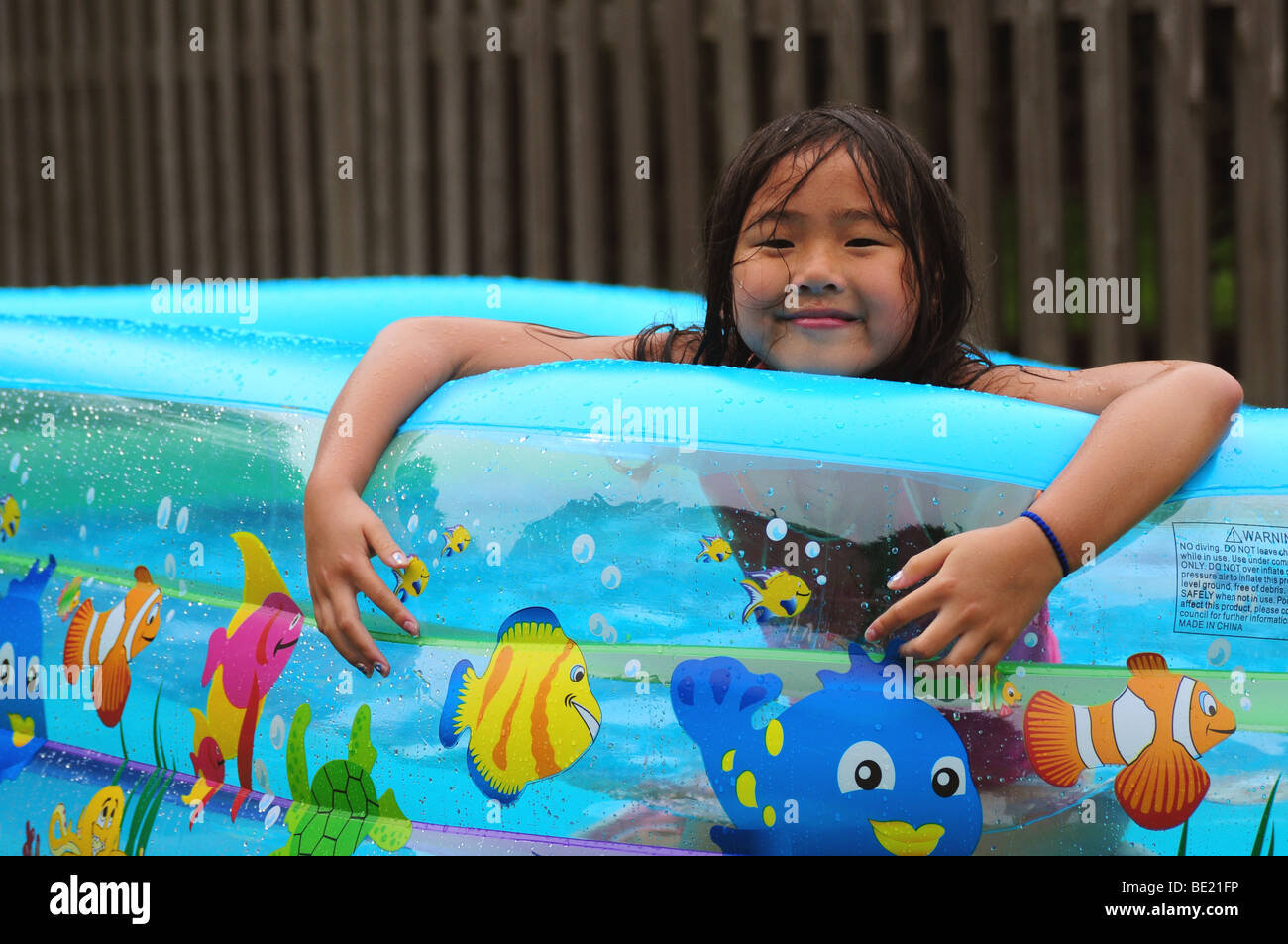 Asian Girl Or Child Playing In An Inflatable Backyard Swimming