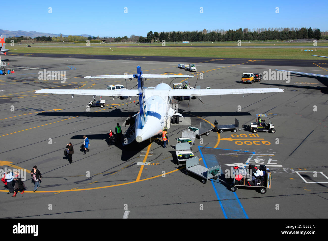Passengers leaving Air New Zealand Link ATR 72 Turbo Prop aircraft at Christchurch Airport,Canterbury,South Island,New Zealand Stock Photo