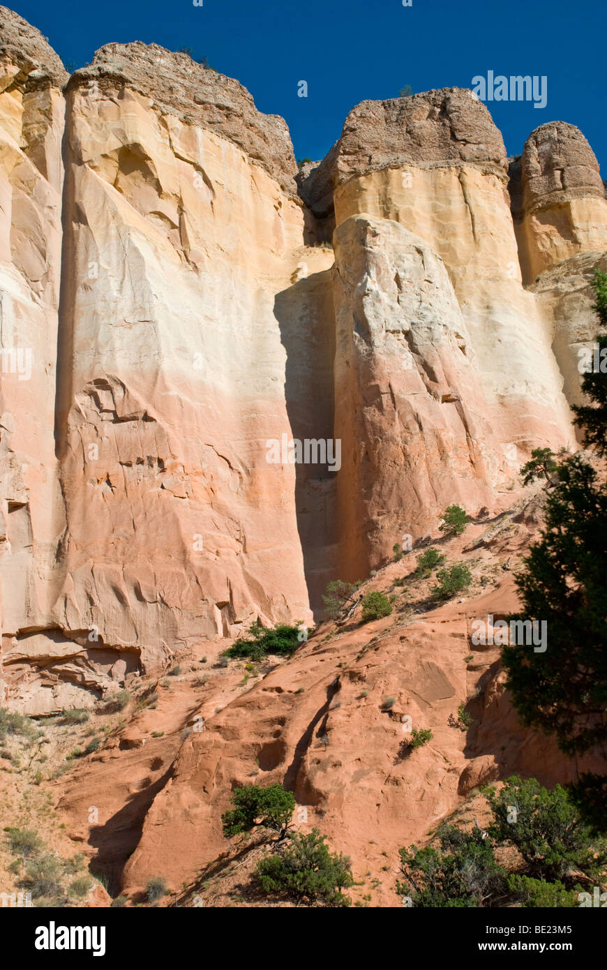 A beautiful red rock cliff  forms the outer walls of 'Echo Amphitheater' in northern New Mexico. Stock Photo