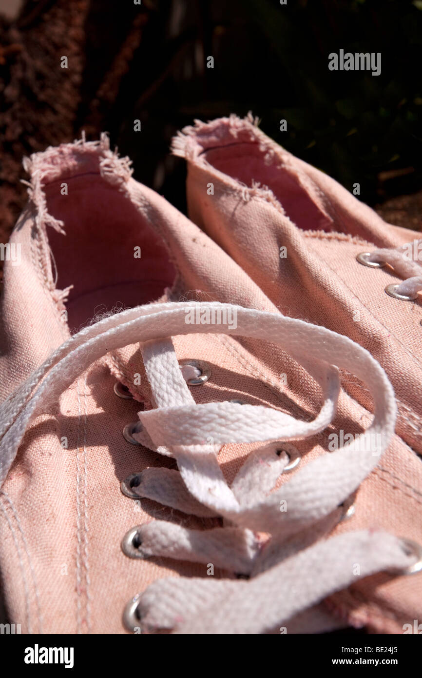 Grubby pink tennis shoes Stock Photo