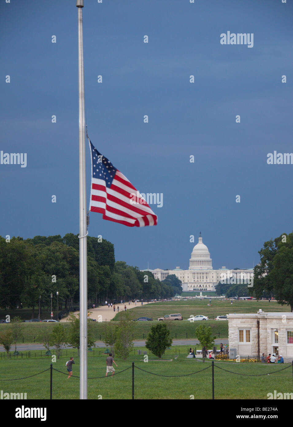 Flags at halfmast near the Washington Monument, with the US Capitol in