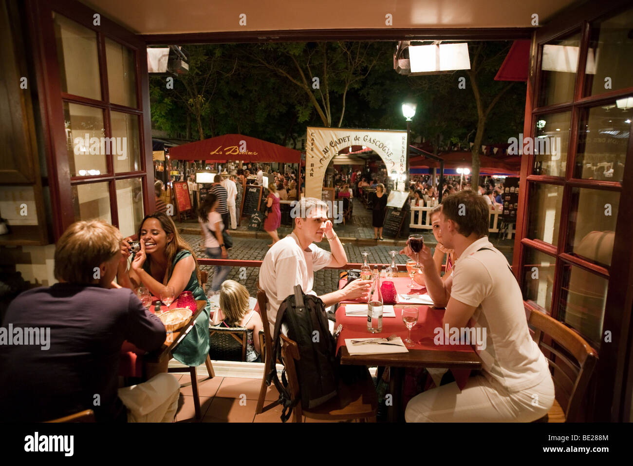 people eating in a cafe restaurant interior in the evening, Montmartre, Paris, France, Europe Stock Photo