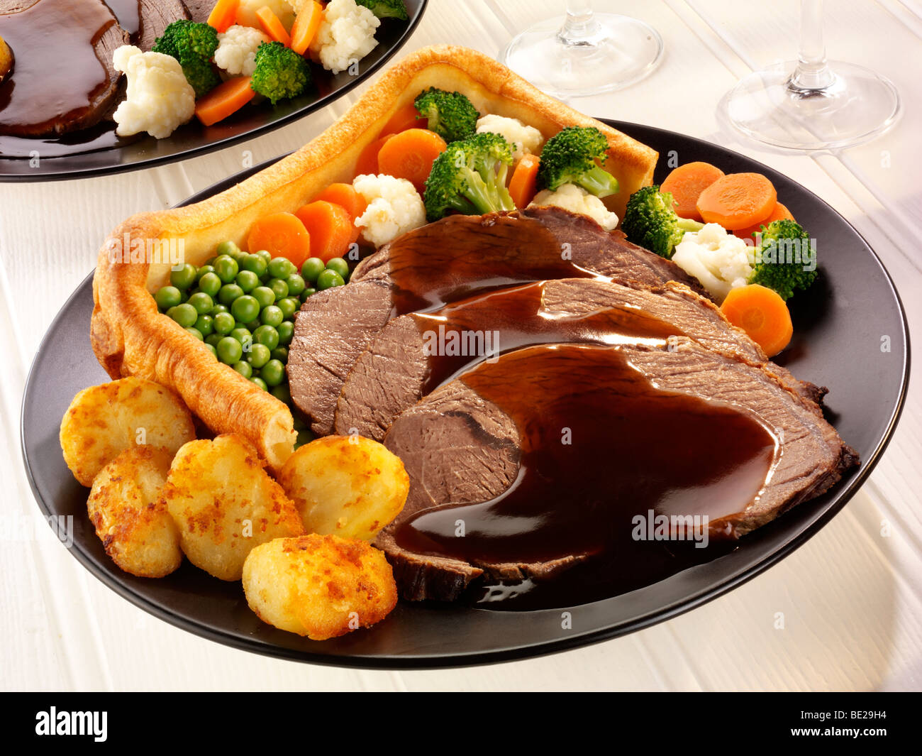 TRADITIONAL ROAST BEEF DINNER WITH YORKSHIRE PUDDING Stock Photo