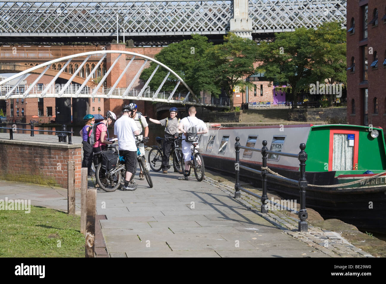 Manchester England UK Group of cyclists on the canal basin towpath of the Castlefields area of the city Stock Photo