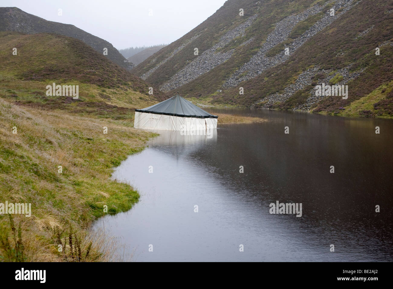 Marquee tent half submerged in lake. Grampian mountains, Scotland Stock Photo