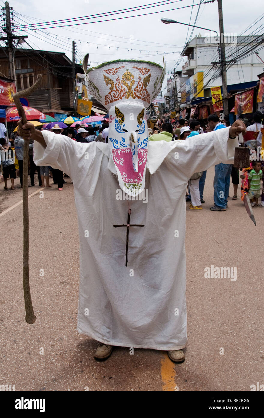 A Thai man wearing a mask and dressed up as a catholic monk during the Phi Ta Khon Festival in Dansai, Loei, Thailand Stock Photo