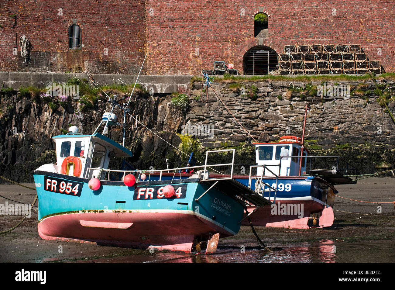 Boats at low tide at Porthgain, Wales Stock Photo