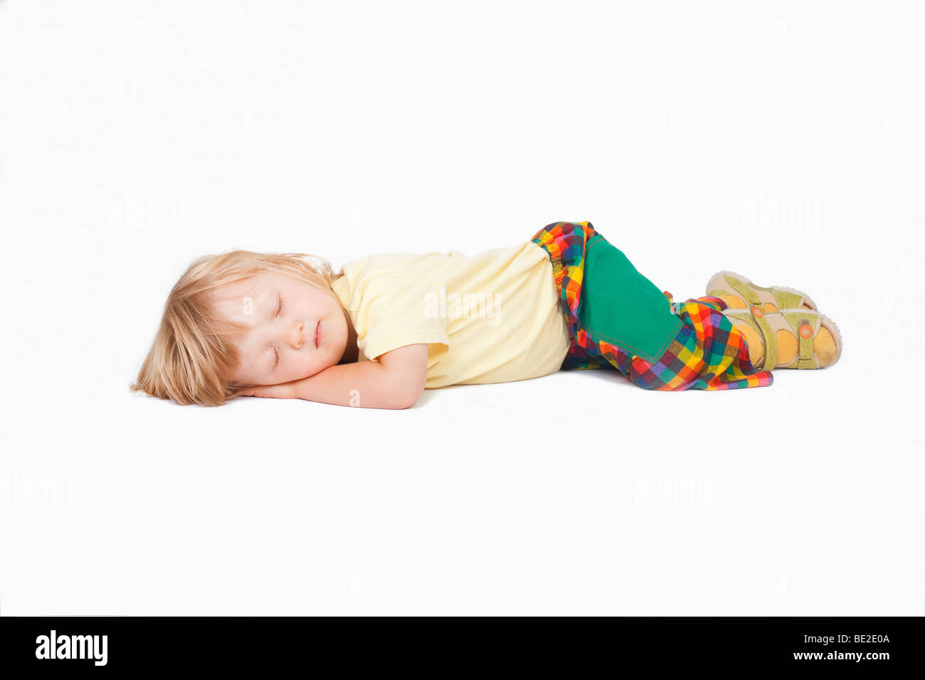 Boy With Long Blond Hair Sleeping On The Floor Clipping Path Stock