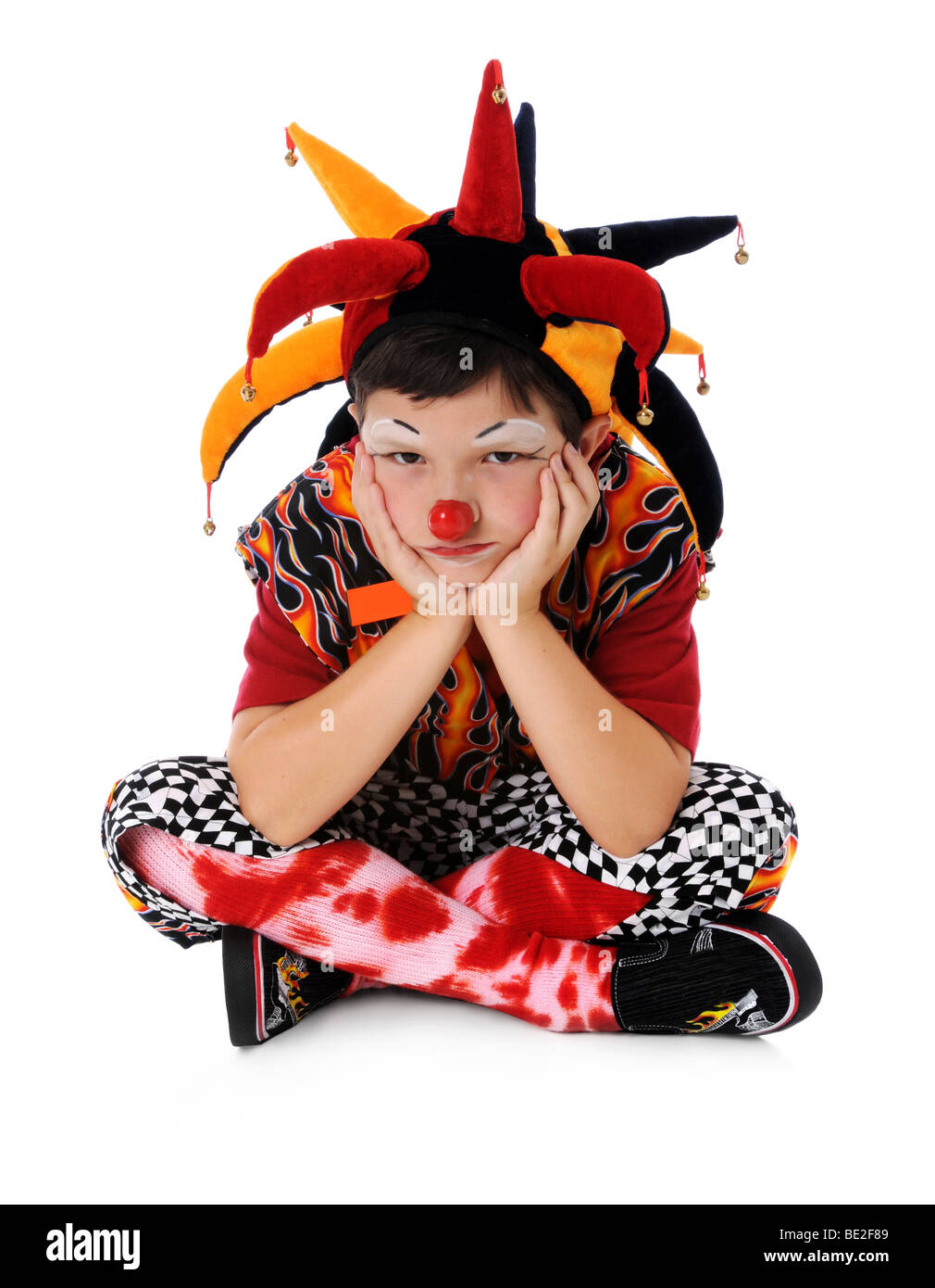Portrait of young clown expressing sadness Stock Photo