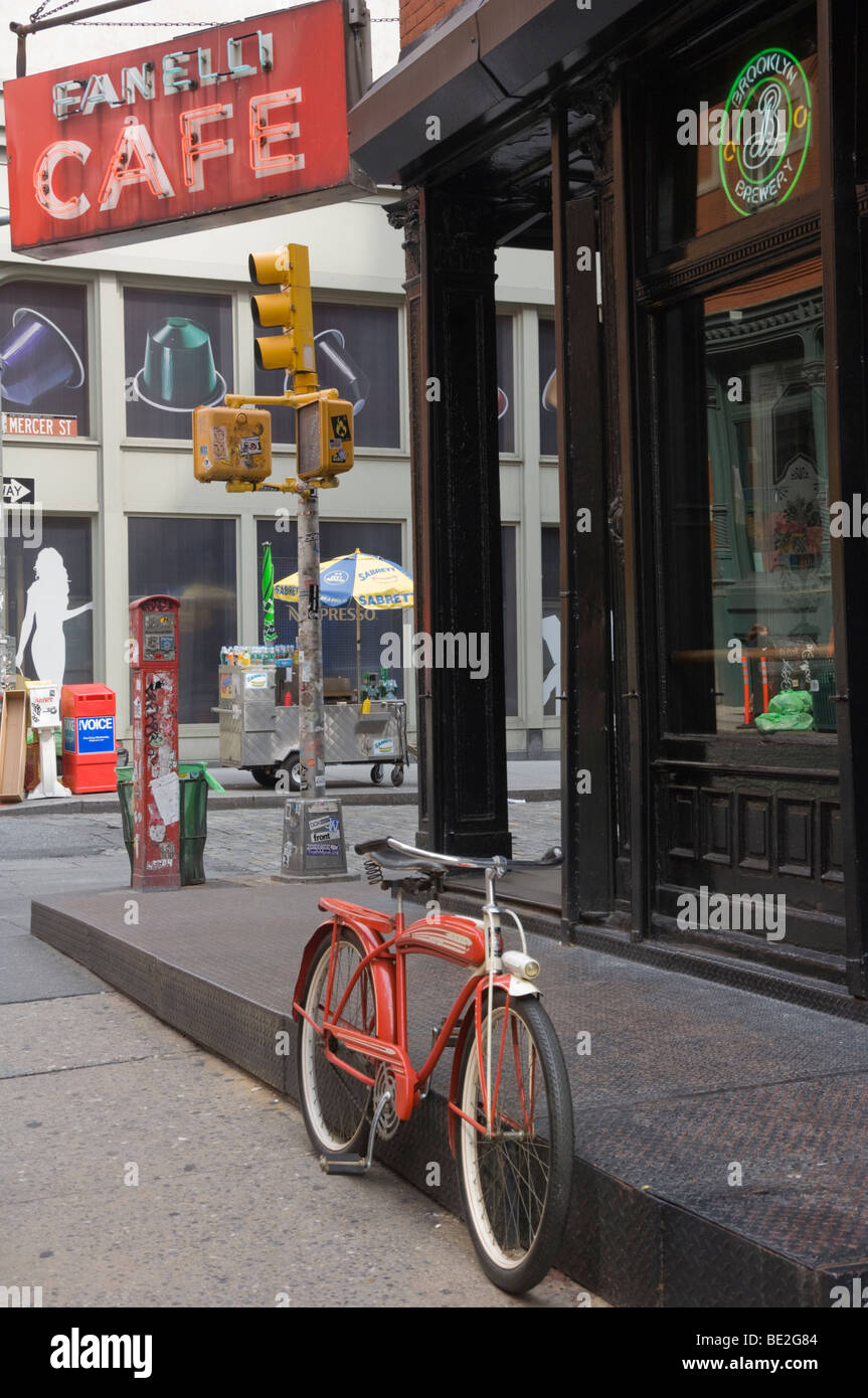 old style red bicycle outside a bar / cafe in new york usa Stock Photo