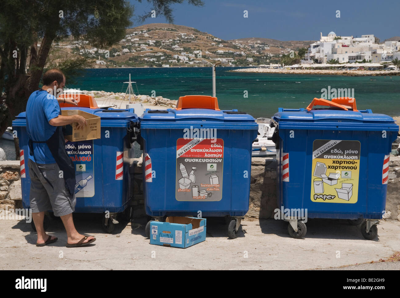 Man sorting rubbish for recycling bins in Greece Stock Photo