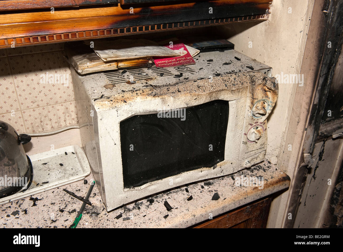 Melted microwave oven following kitchen fire in house Stock Photo Alamy