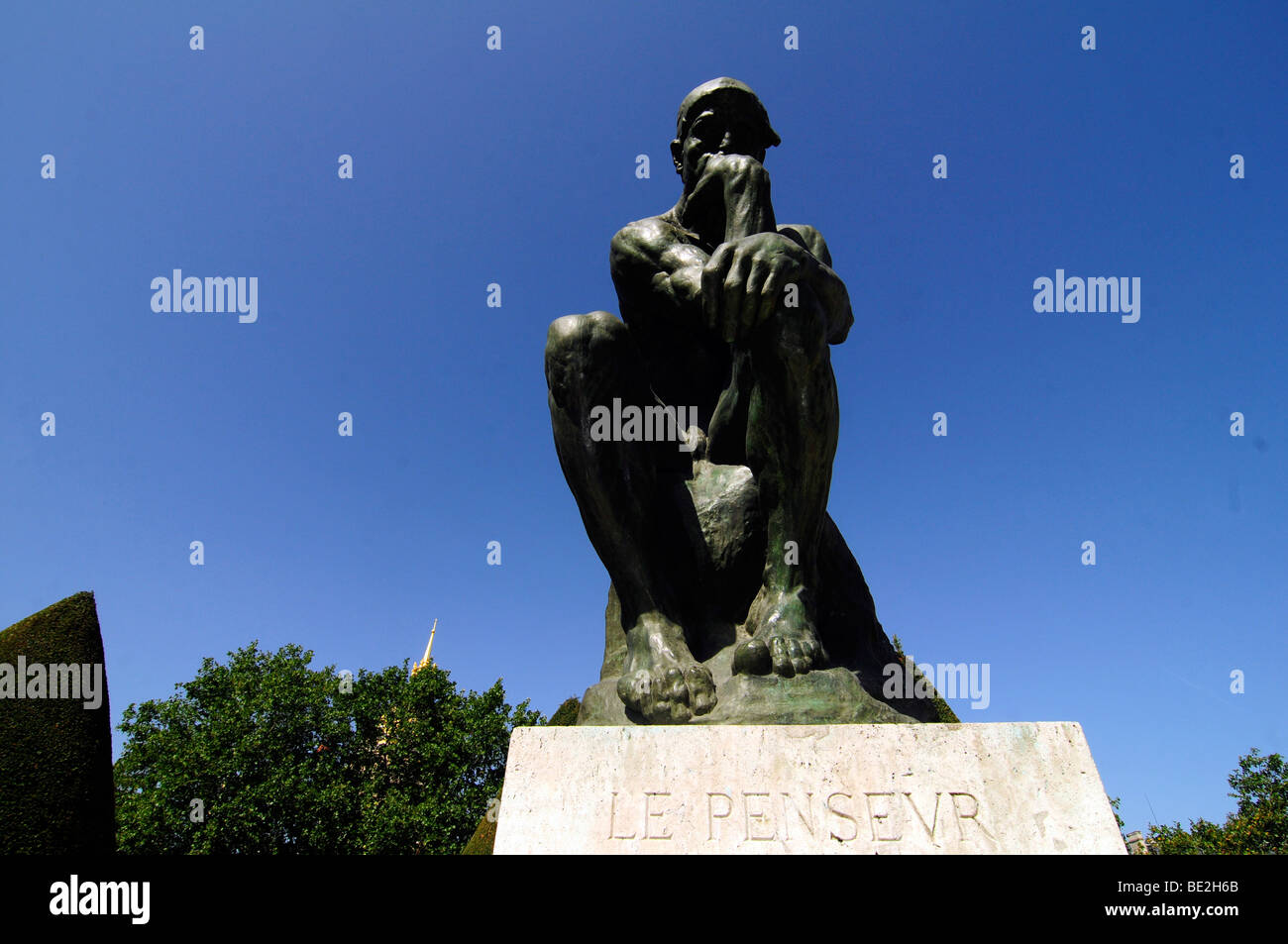 Le Penseur ('the thinker") is Auguste Rodin's masterwork sculpture; on display at the Rodin museum garden in Paris, France. Stock Photo