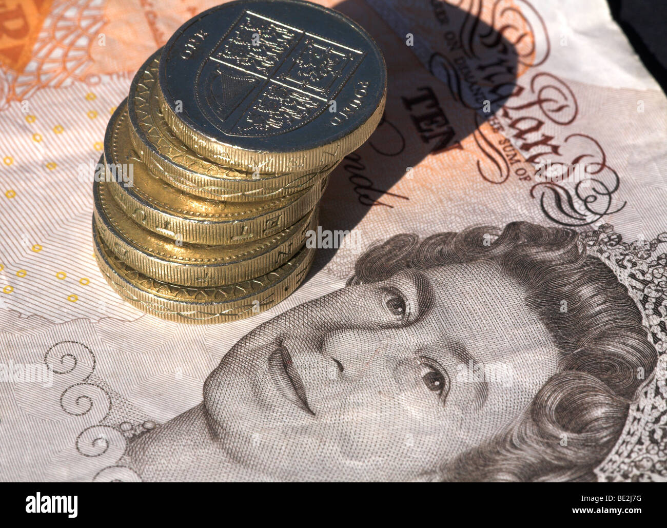 Ten pound note with pound coins Stock Photo