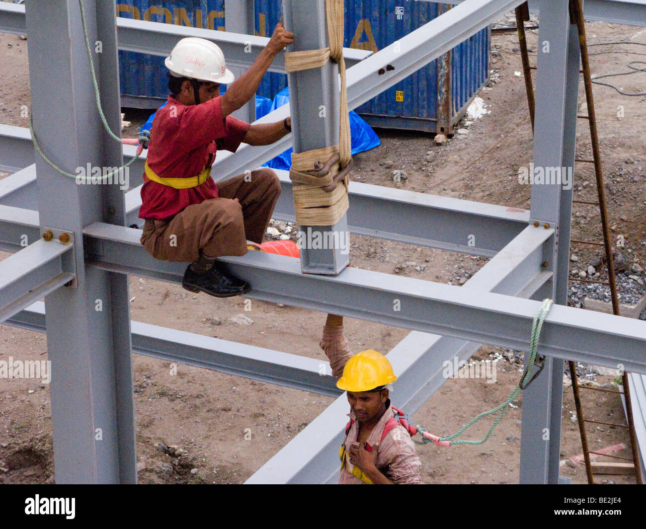Indian construction workers assembling a factory building in an