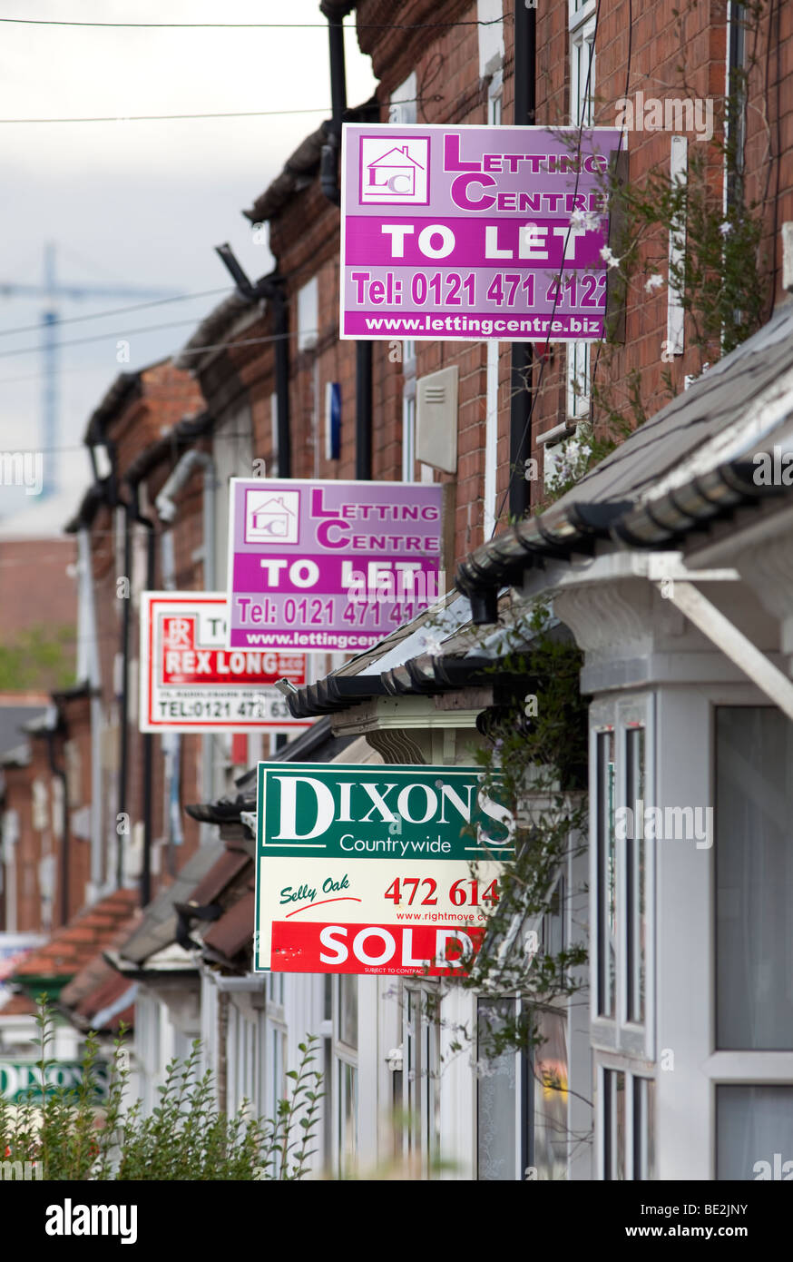 House for sale signs and to let signs on terraced homes in the Selly Oak area of Birmingham, England, UK Stock Photo