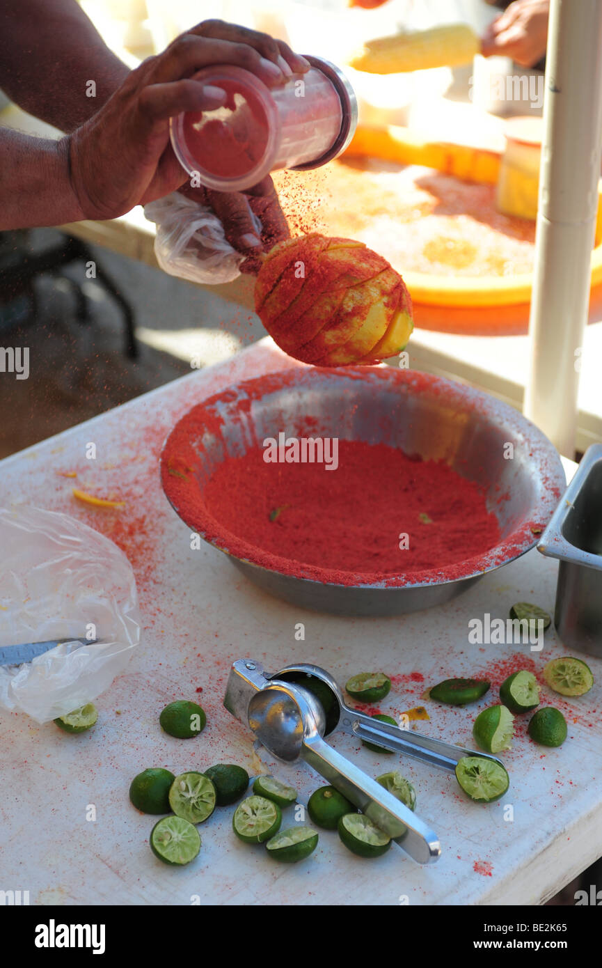 USA Hatch New Mexico- Chile Festival- red chile powder put on a fresh mango Stock Photo