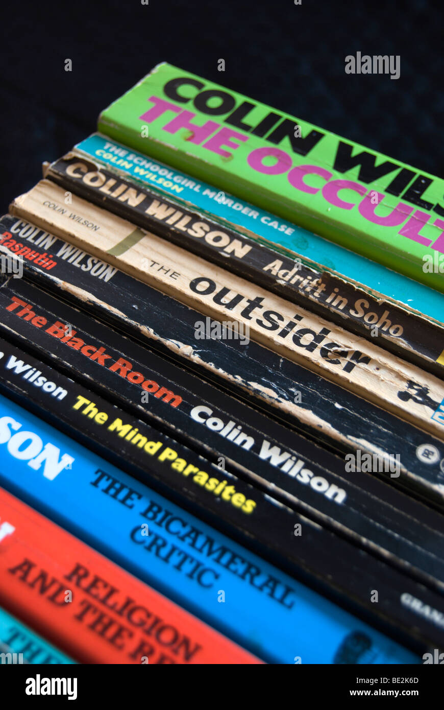 row of books by british author colin wilson, incuding his first and best known work, the outsider Stock Photo