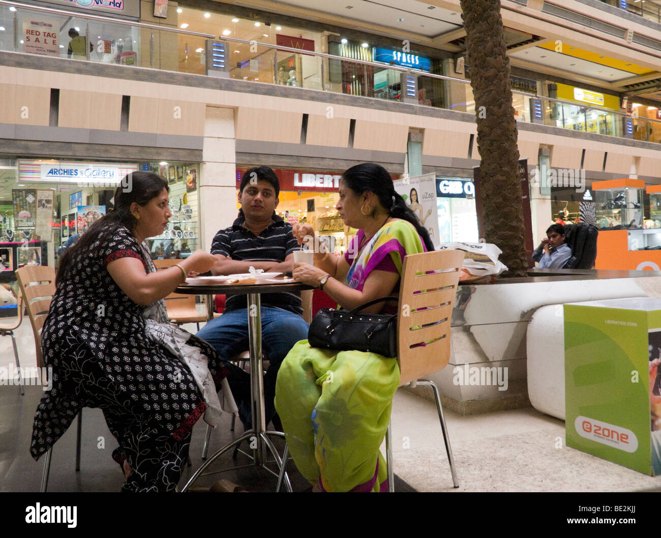 Indian people enjoy a snack at a cafe in the Iscon Mall / shopping mall, in Surat, Gujarat