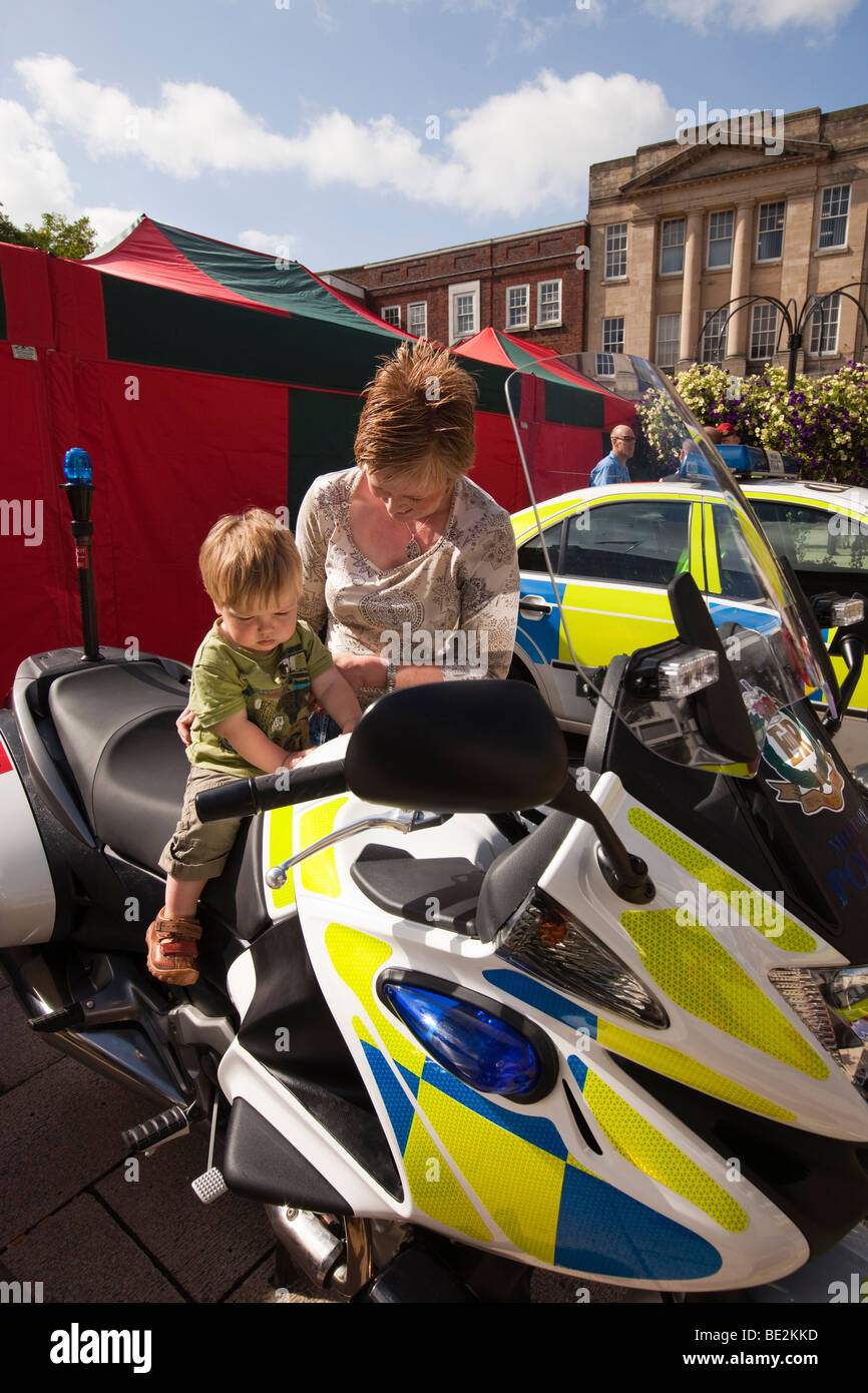 UK, England, Staffordshire, Stafford, Market Square, boy sat on Royal Military Police motorcycle with mother Stock Photo