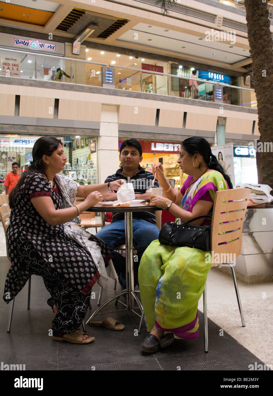 Indian people enjoy a snack at a cafe in the Iscon Mall / shopping mall, in Surat, Gujarat