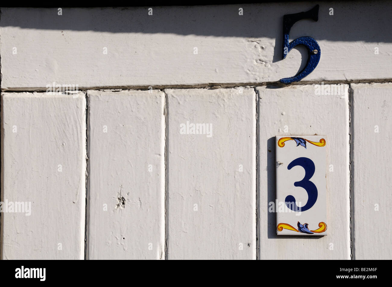 Stock photo of a door with a very confusing numbering system. Is it number 3 or is it number 5 or maybe number 53? Stock Photo