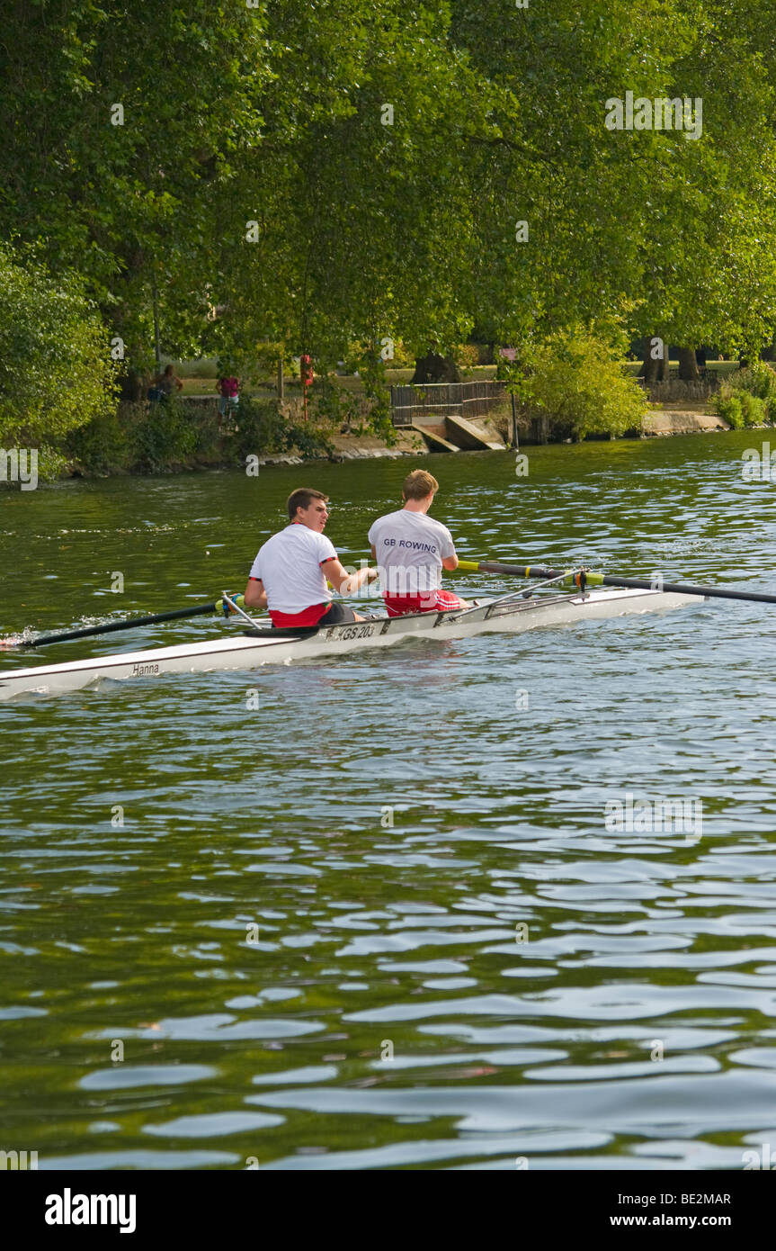 People Rowers Two Young Men sculling Rowing a Scull boat On The River Thames Stock Photo