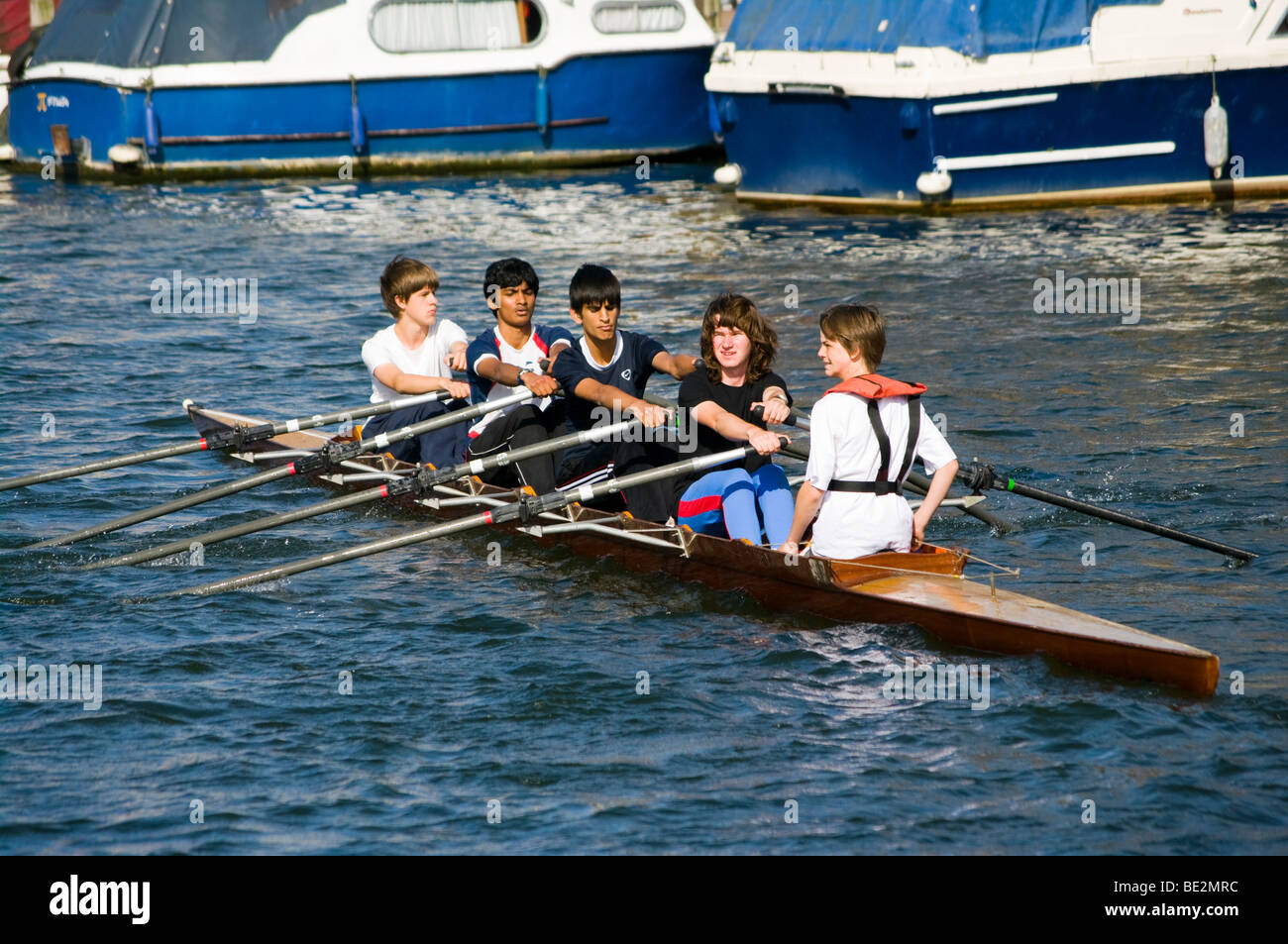 People Rowers Crew Rowing A Coxed 4 Man Scull Boat On The River Thames Kingston Surrey England Stock Photo