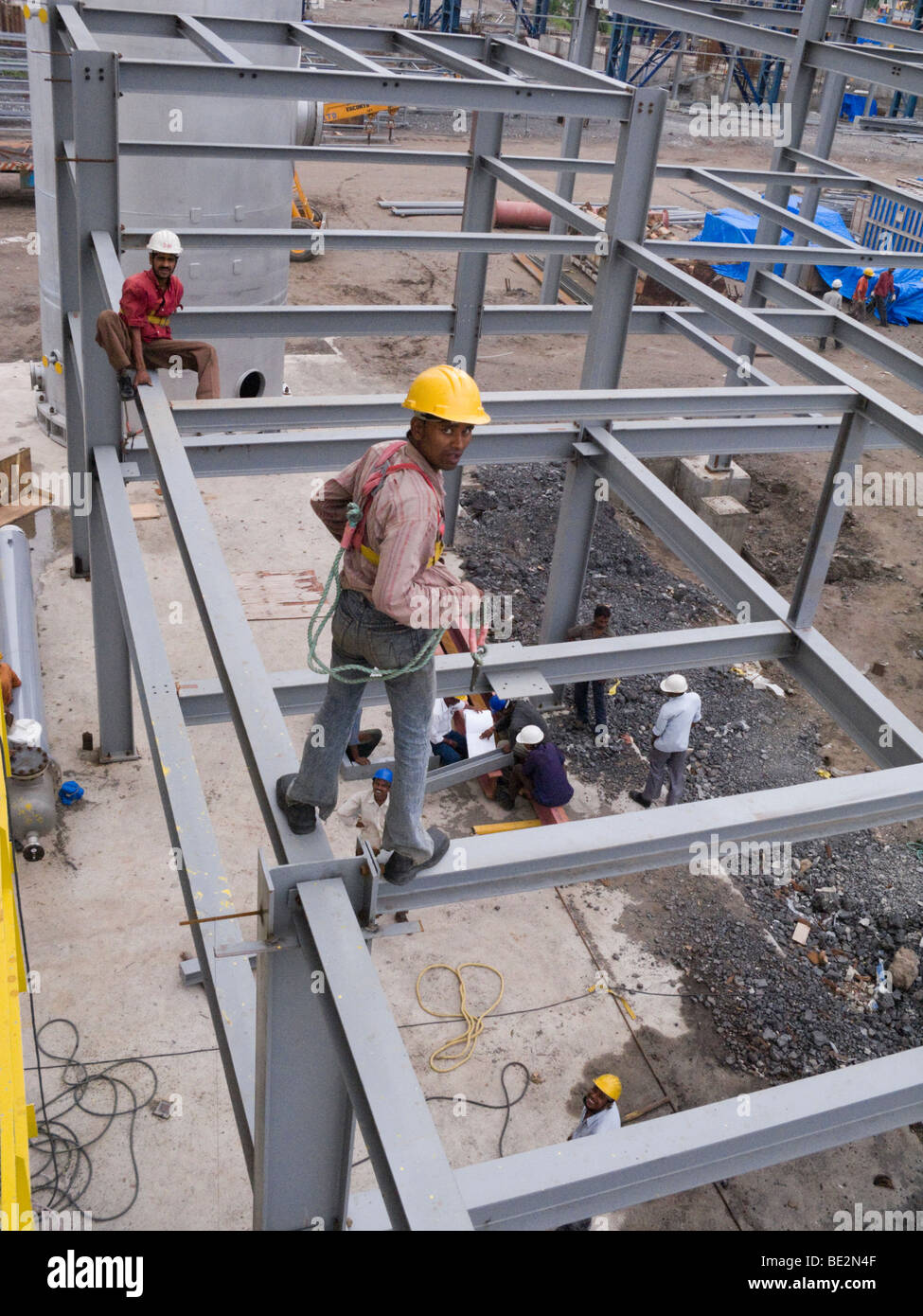 Indian construction workers assembling a factory building in an