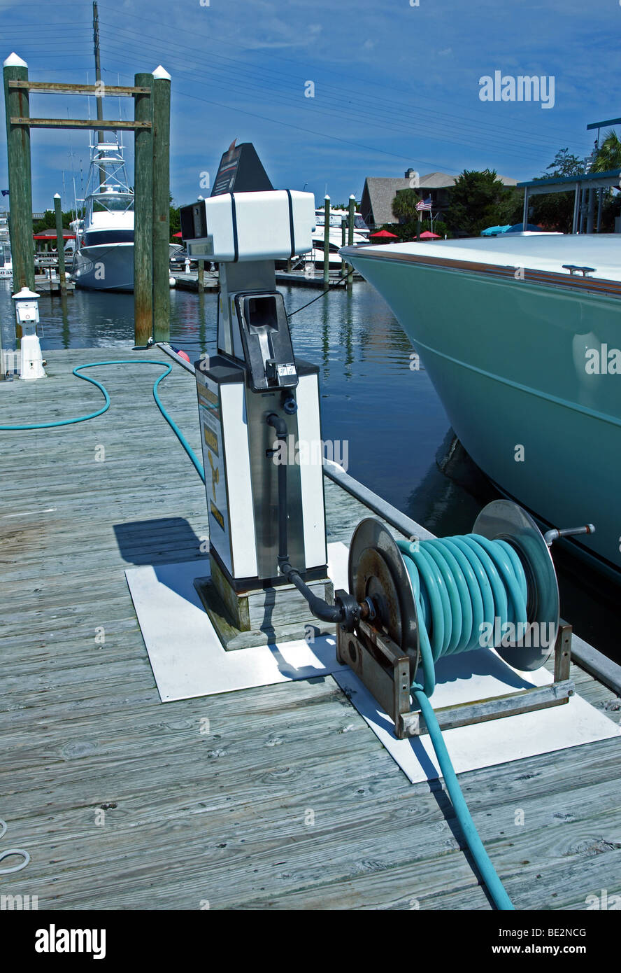 marina on intercoastal waterway with view of fuel pump and hoses next to a boat on a dock in the