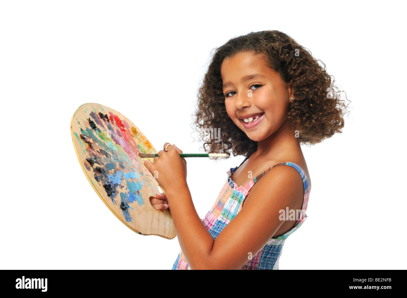 Girl with palette and brush smiling isolated on a white background ...