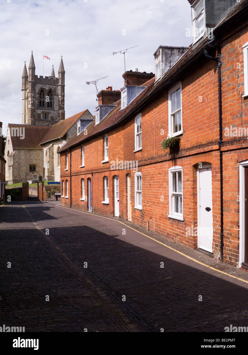Row of Victorian terraced houses / cottages in front of St Andrew's Parish Church. Farnham. Surrey. UK. Stock Photo