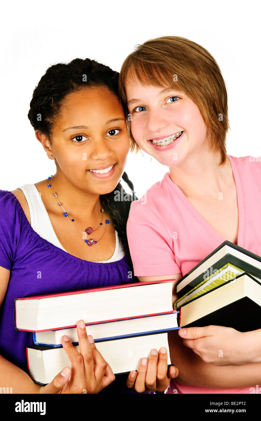 Isolated portrait of two teenage girls holding text books Stock Photo ...