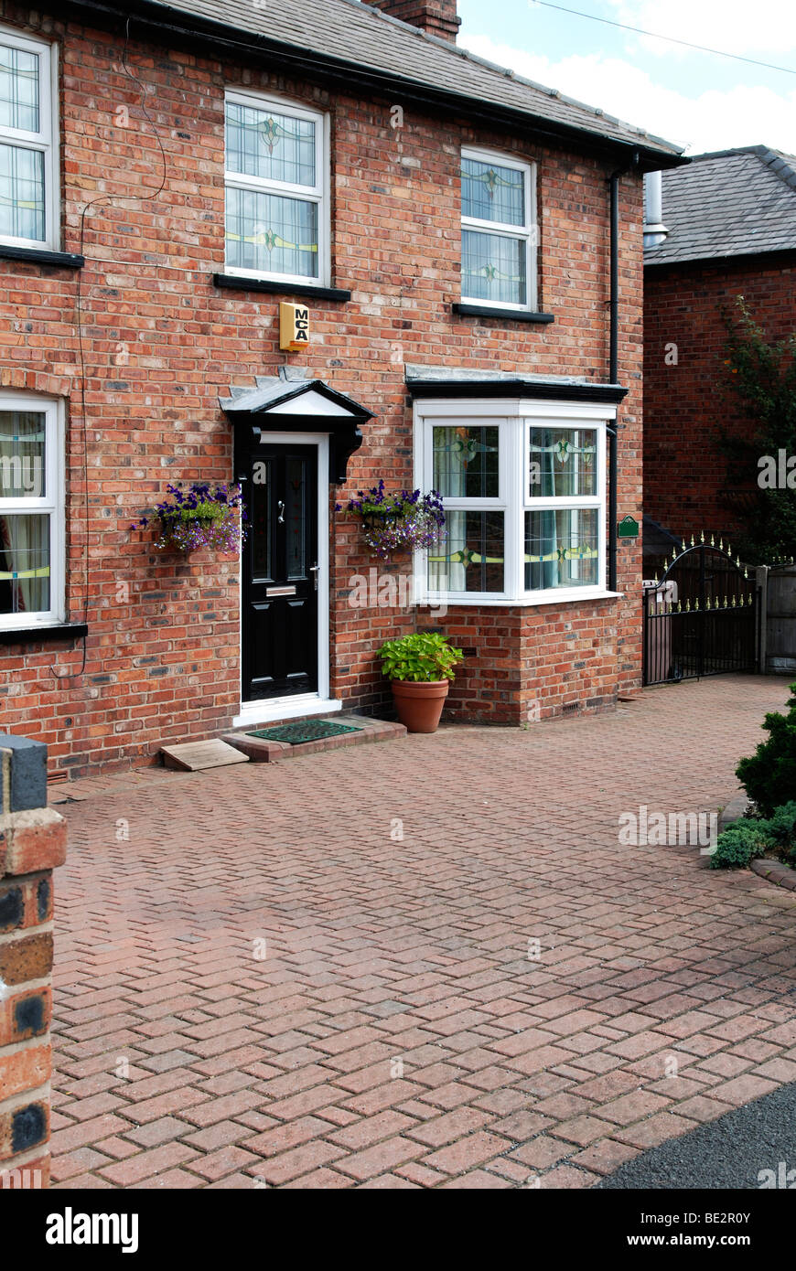 a 1930,s house with a modern block paving driveway Stock Photo