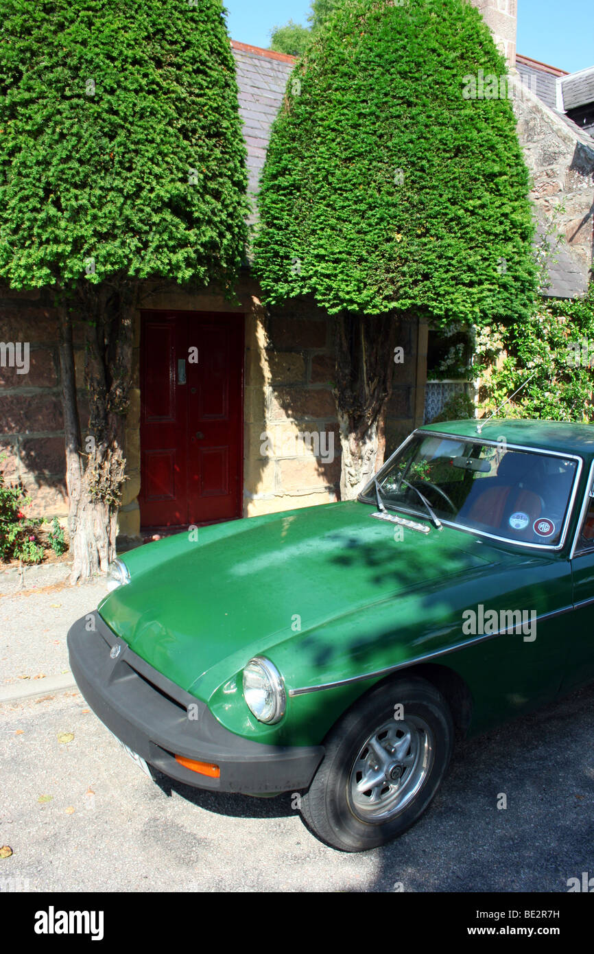 MGB sportscar parked outside pretty terraced cottage in Dornoch, Sutherland, north-east Scotland Stock Photo