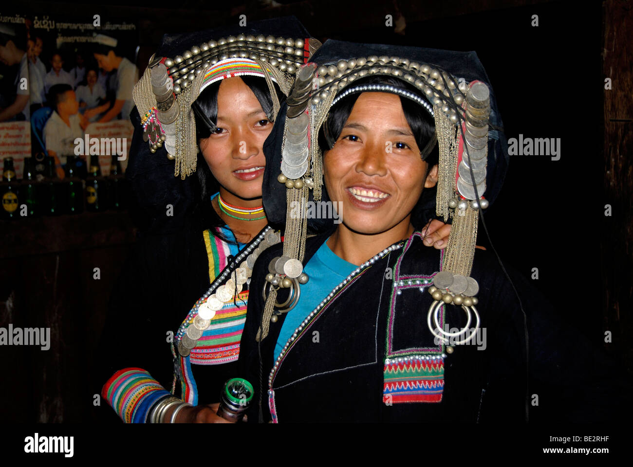 Portrait, ethnology, young Akha Pixor women smiling and wearing silver headdresses and coins, village of Ban Moxoxang, Phongsal Stock Photo