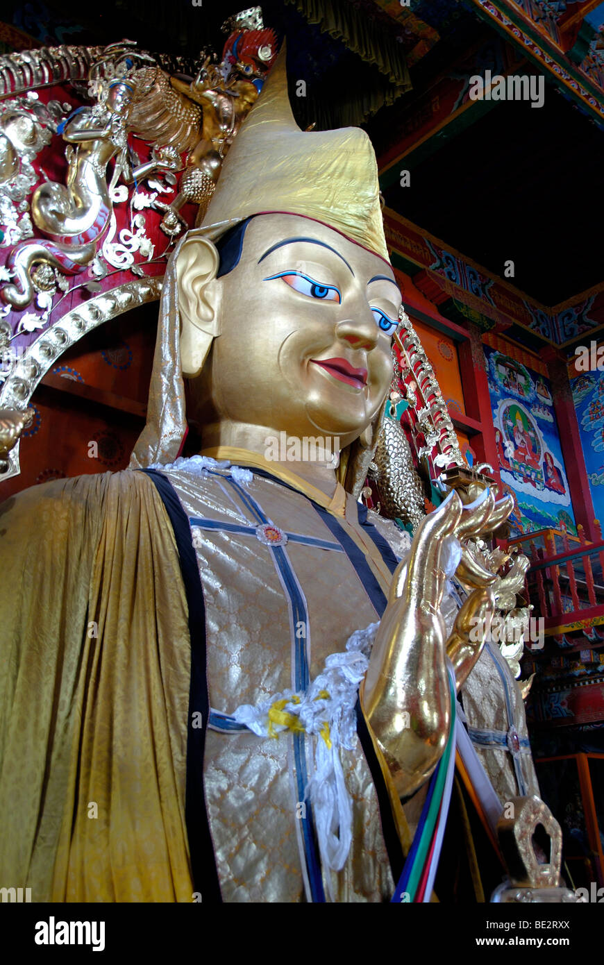 Tibetan Buddhism, large statue of Llama Tsongkharpa, Gelug school, yellow caps, mudra, hand position, Monastery Ganden Sumtseli Stock Photo