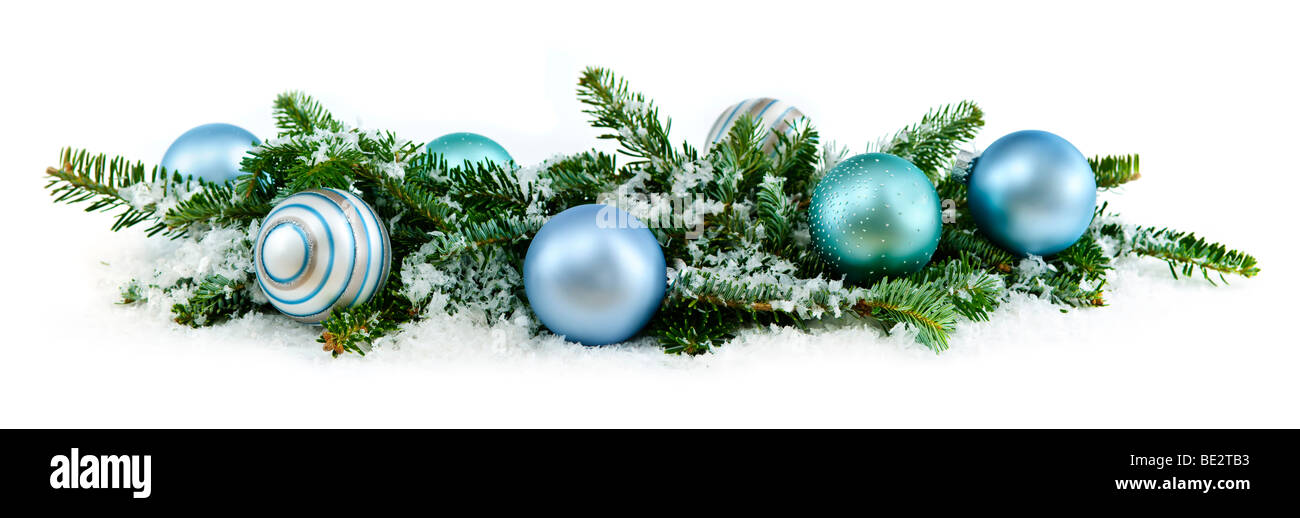 Many Christmas decorations laying in pine branches and snow Stock Photo