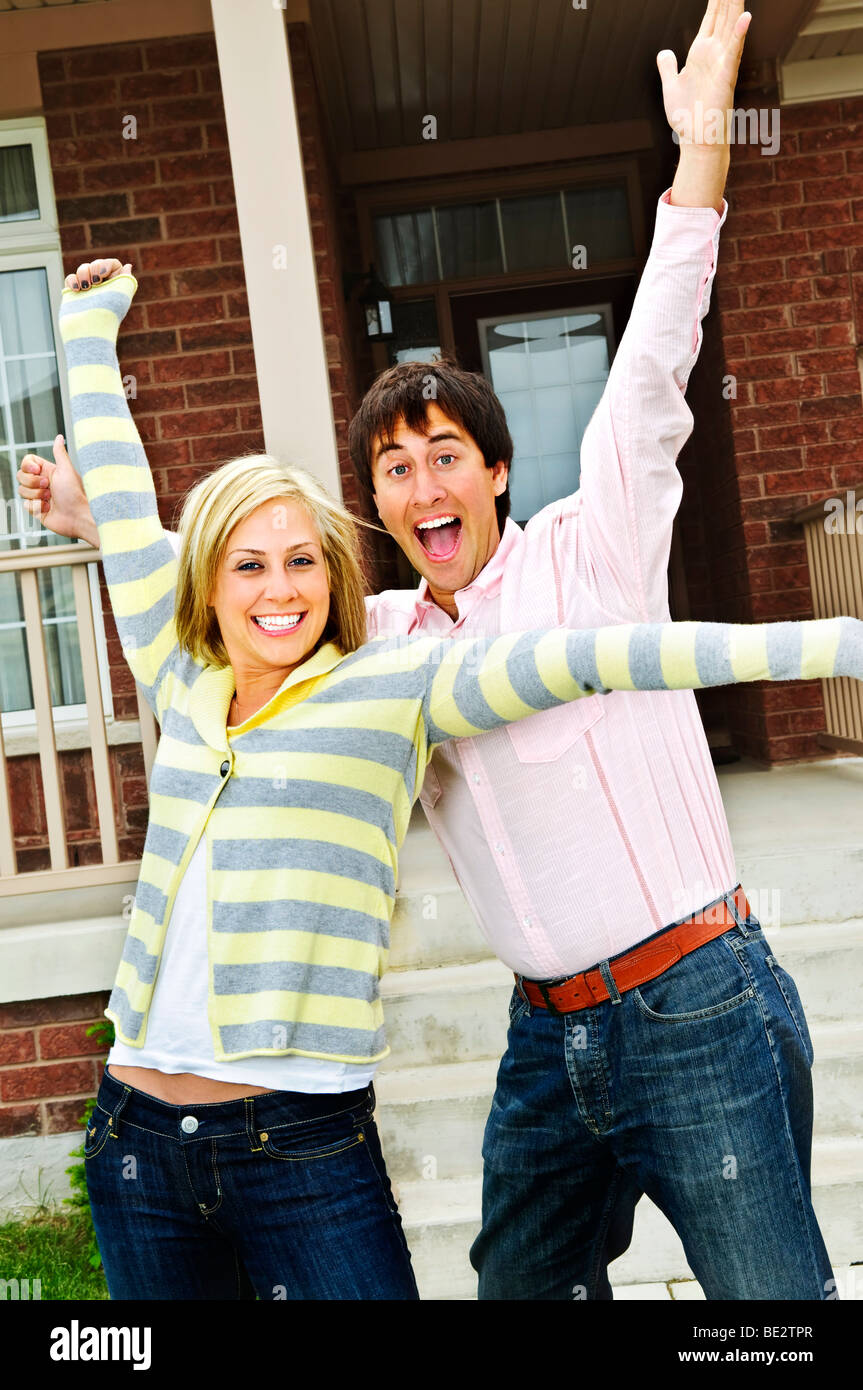 Excited young man raising arms hi-res stock photography and images - Alamy