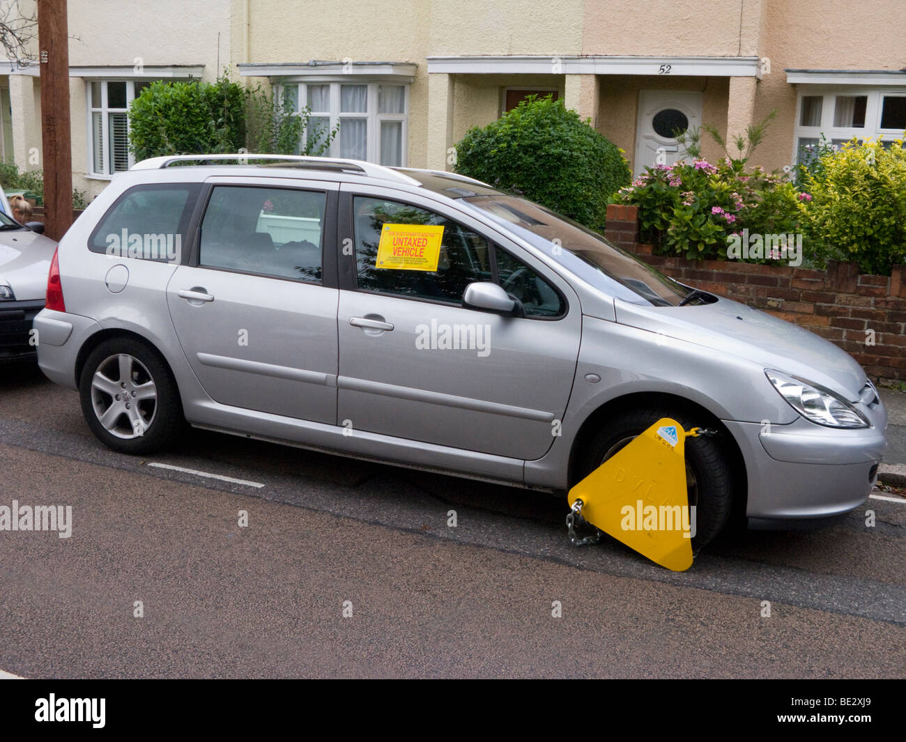 A wheel clamp fitted by the DVLA to a car whose keeper has not paid vehicle tax / has valid TAX