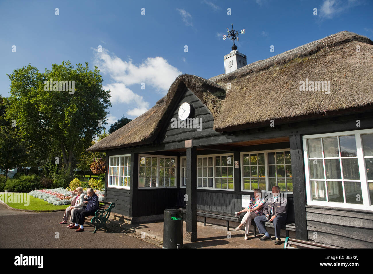 UK, England, Staffordshire, Stafford, Victoria Park, bowls pavilion retired people sat watching game in sunshine Stock Photo