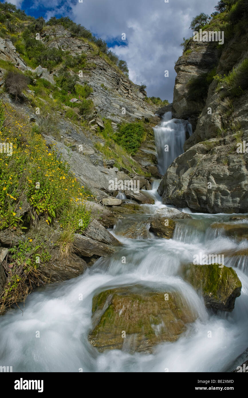 Mountain stream with a waterfall in Skippers Canyon, Queenstown, South Island, New Zealand Stock Photo