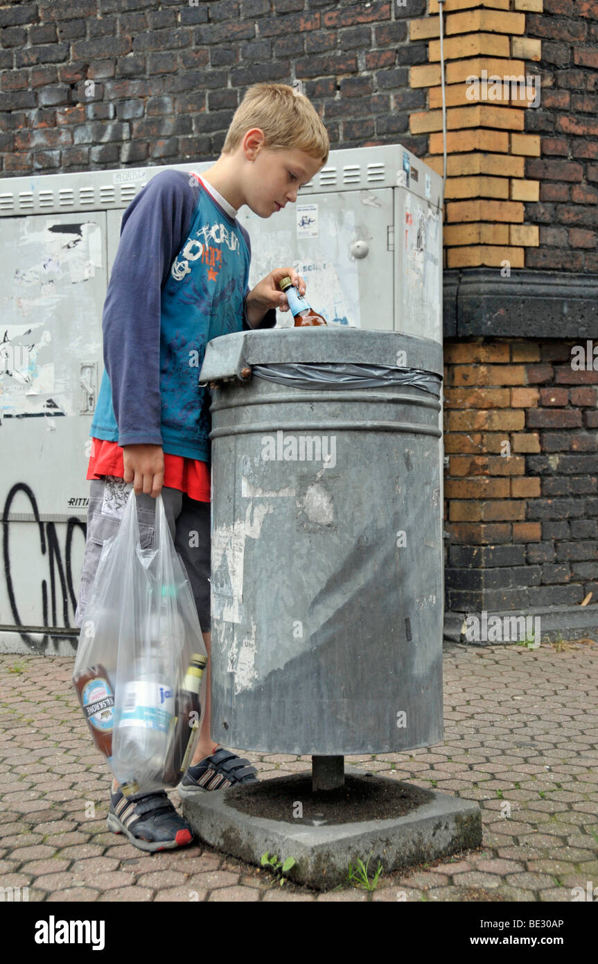Boy, 9, earning pocket money by collecting empty deposit bottles, Germany, Europe Stock Photo
