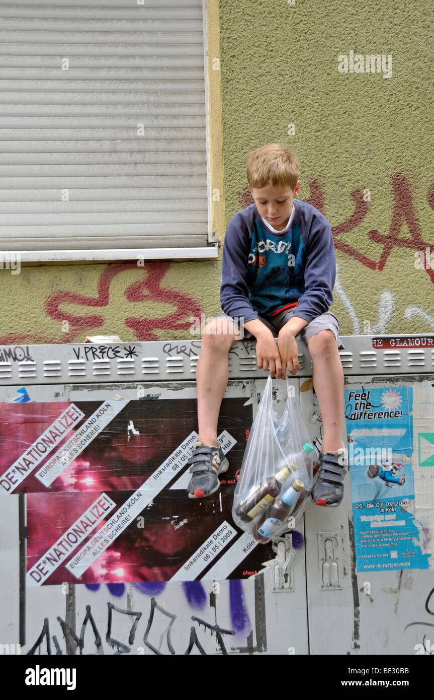 Boy, 9, earning pocket money by collecting empty deposit bottles, Germany, Europe Stock Photo