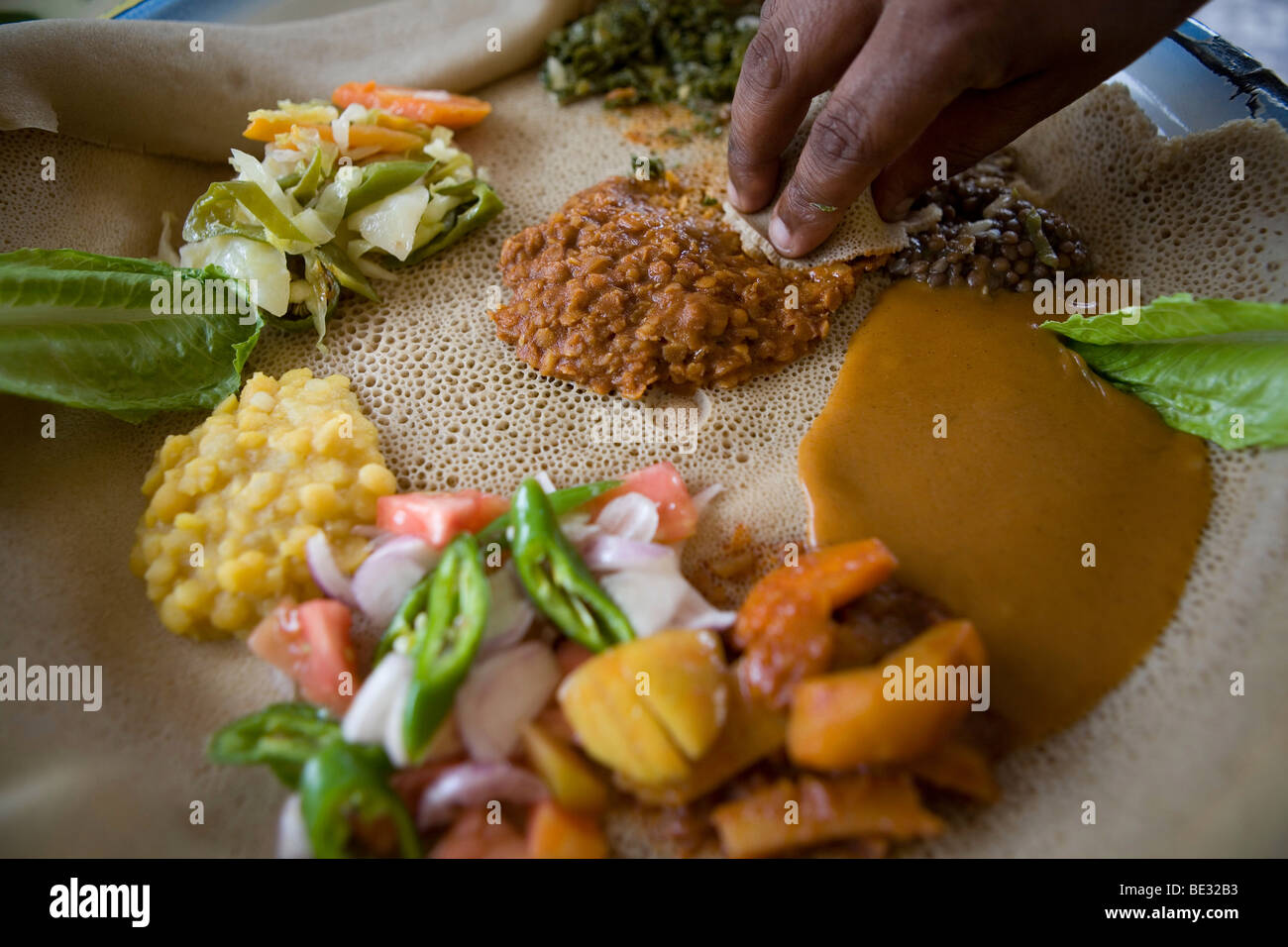 most important part of an Ethiopian meal is the Injerra, a sort of pancake made of "Teff". The injerra is eaten with hands. The Stock Photo