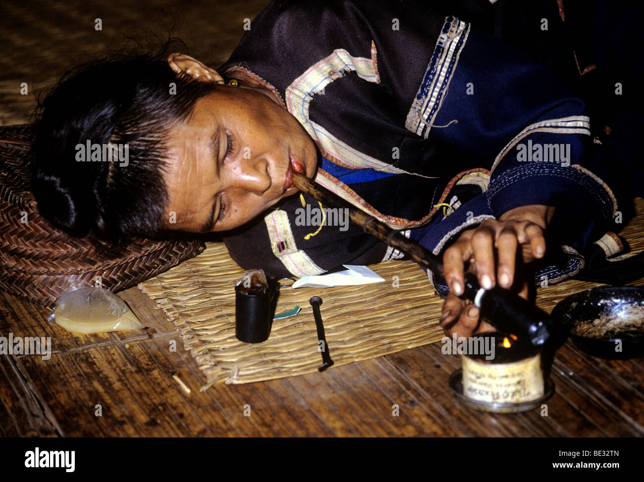 2695. Woman of the Black Lahu Hill Tribe smoking opium, Northern Thailand. Stock Photo