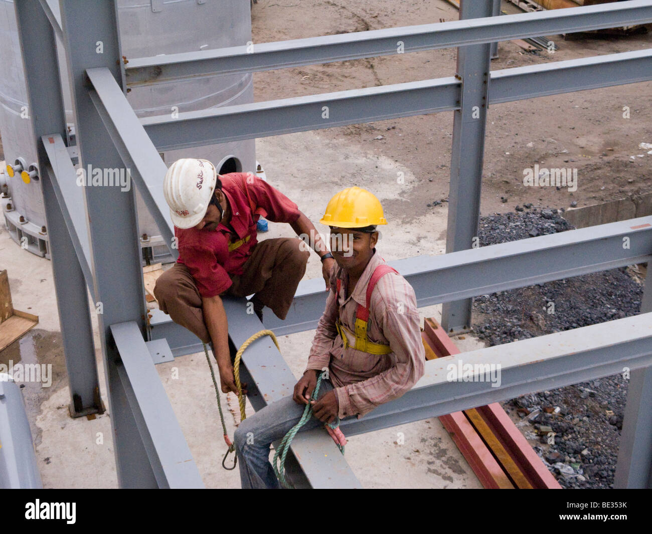 Indian construction workers assembling a factory building in an