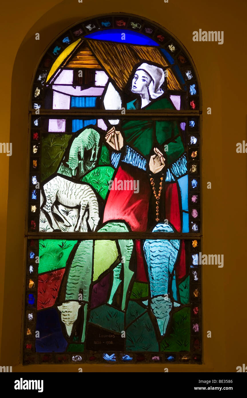 stained window of Bernadette Soubirous grazing sheep Stock Photo